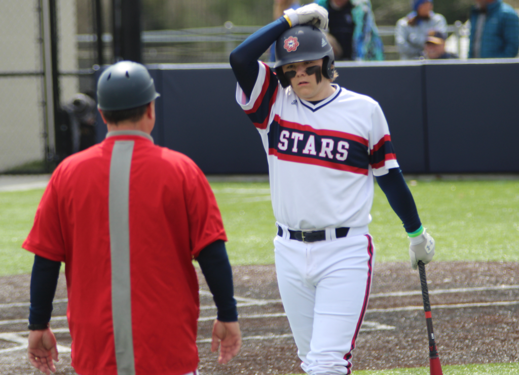 Senior Kylar Fisher discusses his upcoming at bat with Coach Callahan